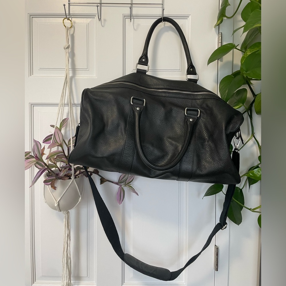 Cole Haan black leather duffel bag.